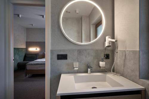 a bathroom with a sink and a mirror at Hotel Vedmezhyi Dvir in Bukovel