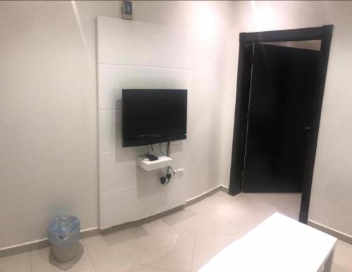 um quarto com uma televisão de ecrã plano na parede em Al Makan 107 Hotel by Al Azmy em Riade