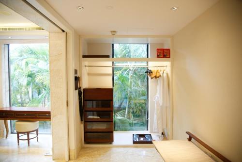 a room with a bed and a window at Wanda Reign Resort & Villas Sanya Haitang Bay in Sanya