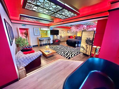 a living room with pink walls and a living room with a couch at Beyond - Romantic Basement Apartment - Close To Beach - With Parking in Bournemouth
