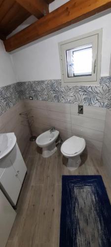 a bathroom with two toilets and a window at Mission Relax 4 in Lampedusa