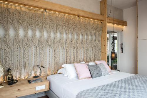 a bedroom with a bed with pink pillows at Domus Aqua in Kato Daratso