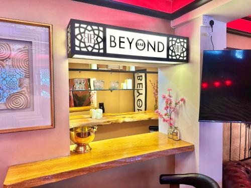 a room with a sign that says beyond on a wall at Beyond - Romantic Basement Apartment - Close To Beach - With Parking in Bournemouth