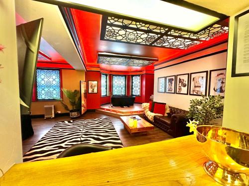 a living room with a couch and a table at Beyond - Romantic Basement Apartment - Close To Beach - With Parking in Bournemouth