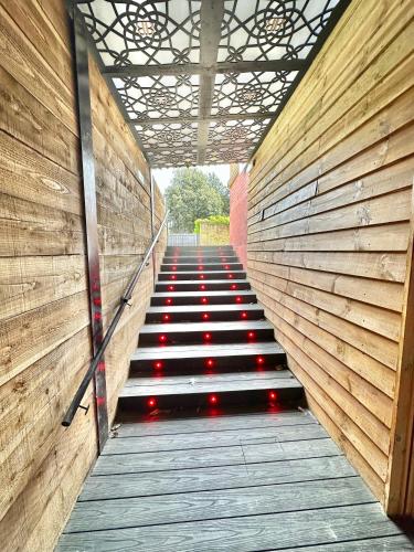 a set of stairs with red lights on them at Beyond - Romantic Basement Apartment - Close To Beach - With Parking in Bournemouth