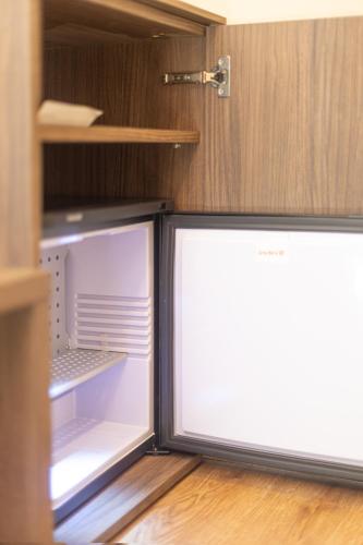 an empty refrigerator and freezer in a kitchen at Le Fare in Fara Novarese