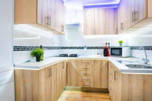a kitchen with wooden cabinets and a sink at Sollana Arena in Valencia