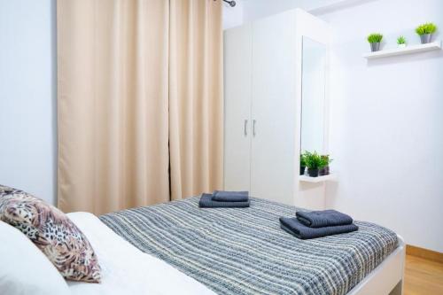 a bedroom with a bed with blue towels on it at Sollana Arena in Valencia