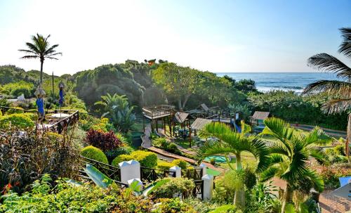 a view of a resort with the ocean in the background at Pumula Beach Hotel in Umzumbe