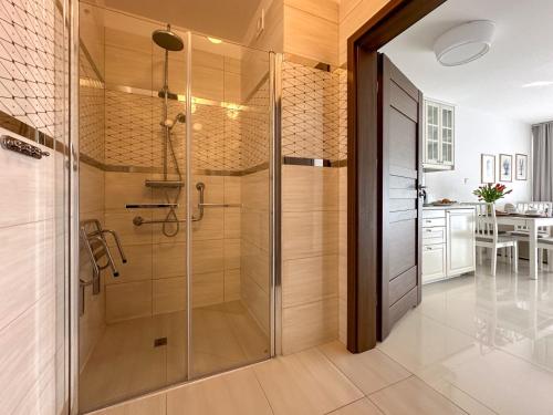 a bathroom with a shower with a glass door at SPOT JURATA in Jurata