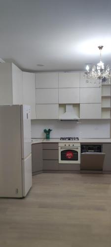 a kitchen with white cabinets and a stove top oven at SABURTALO in Agaraki