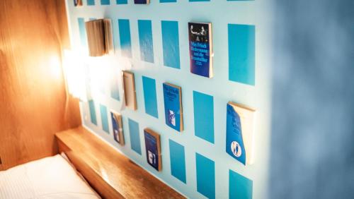 a wall with a bunch of pictures on it at Boutique Hotel Kronenhof in Zürich