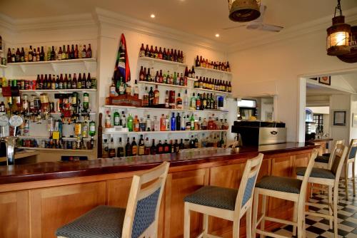 a bar with a lot of bottles of alcohol at Pumula Beach Hotel in Umzumbe