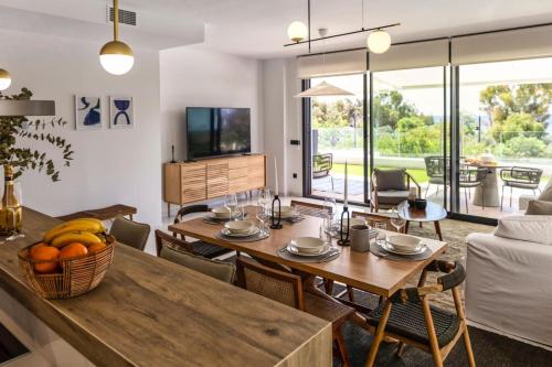 a living room with a table and chairs and a couch at Luxury Sea View Apartment by United Renters in Villajoyosa