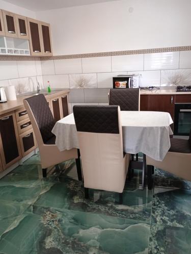 a kitchen with a table and chairs with a glass floor at NICO-ȘTEF in Vatra Dornei