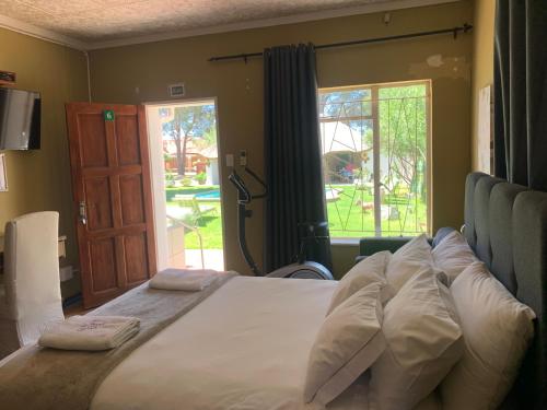 Ένα ή περισσότερα κρεβάτια σε δωμάτιο στο Victoria Oaks Guesthouse