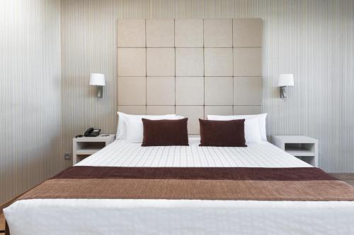 Ένα ή περισσότερα κρεβάτια σε δωμάτιο στο Hotel Best Semiramis