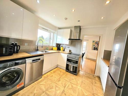 a kitchen with a washer and a dishwasher at 3 Bed House with 6 Beds by Sensational Stay in Edinburgh