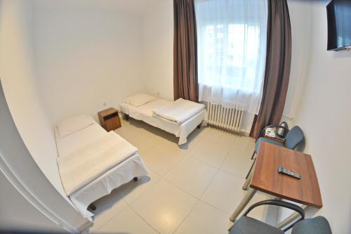 a hospital room with two beds and a window at Twój Hostel Klimczoka 7 in Katowice