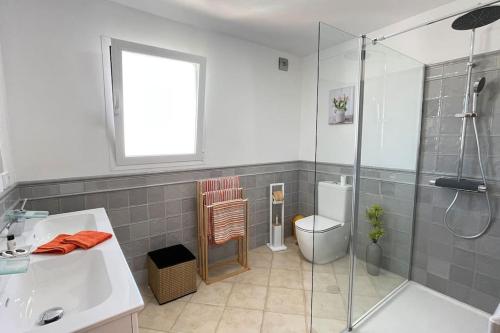 a bathroom with a shower and a sink and a toilet at Casa Azahar luxury two bedroom top floor apartment in Alhaurín el Grande
