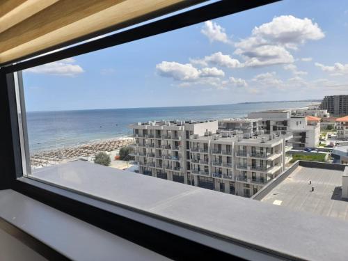 a view of the beach from a window of a building at Apartament Palma 2 Stefan Resort in Mamaia Sat/Năvodari