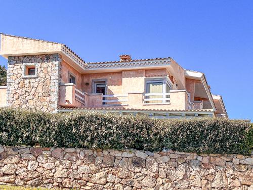 a house on top of a stone wall at Cala Reale 101 in Capo Testa