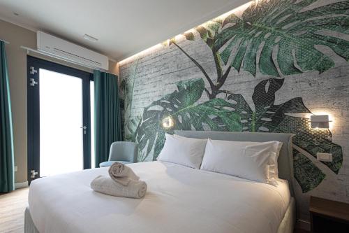 a bedroom with a large white bed with a mural on the wall at Le Fare in Fara Novarese
