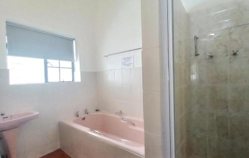 a bathroom with a shower and a tub and a sink at Koo Karoo Guest Lodge and Self Catering in Montagu