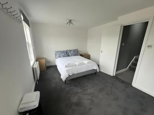 a bedroom with a bed in a white room at 1-Bedroom Flat in Islington! in London