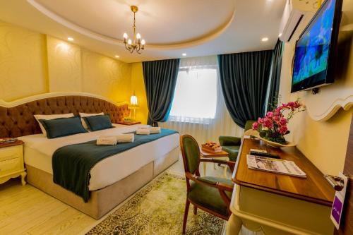 a hotel room with a bed and a television at Anatolia Hotel Airport in Trabzon