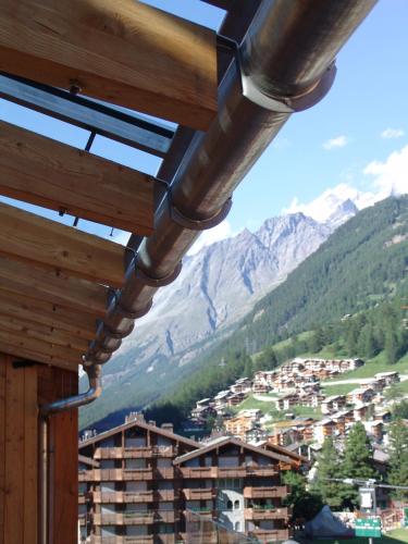 a view of a mountain village from a building at Backstage Boutique SPA Hotel in Zermatt