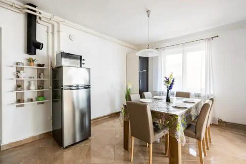 a kitchen and dining room with a table and a refrigerator at Apartment Tomas,,,Spacious house with private parking,terrace,5G Internet,,,,, in Zadar