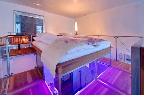 a bedroom with a bed on a glass platform at Backstage Boutique SPA Hotel in Zermatt