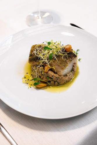 a white plate with a piece of food on a table at Land of Alandroal in Alandroal