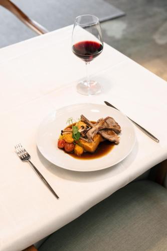 a plate of food and a glass of wine on a table at Land of Alandroal in Alandroal