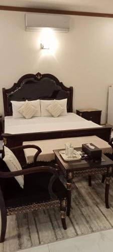 a bedroom with a bed and a coffee table at SeaView Family Guest House Small Bukhari in Karachi