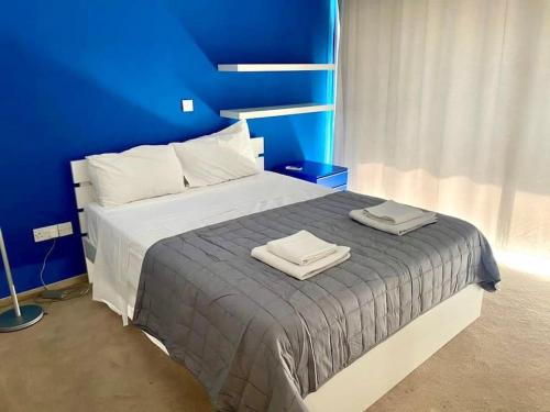 a bedroom with a bed with two towels on it at Modern Apartment near the Center by Platform 357 in Strovolos
