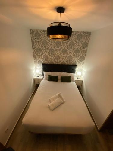 a bedroom with a white bed with a pillow on it at Moncloa Urban Apartment in Madrid