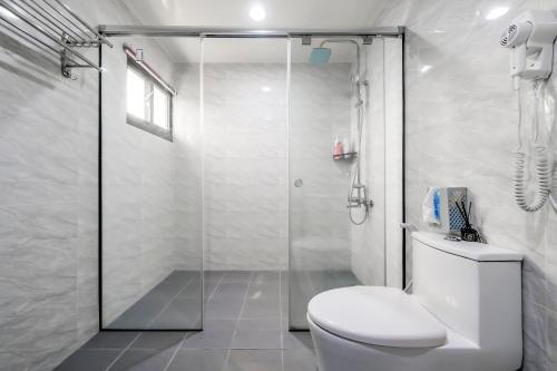 a white bathroom with a shower and a toilet at Aleopard in Wu-k'an