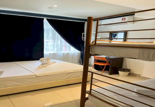 a bedroom with two bunk beds and a window at OYO 90970 Senja Hostel Chinatown in Kuala Lumpur