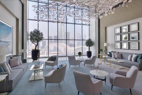 a living room with couches and chairs and a large window at The Address Fountain Views - Residence 2 Bedroom with Burj Khalifa view in Dubai