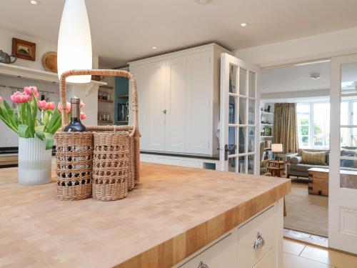 a kitchen with a counter with a bottle of wine at Beta Cottage in Southwold