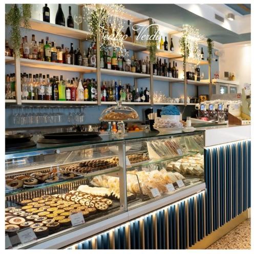 a bakery display case with many different types of donuts at Pep's Rooms by the sea in Trieste