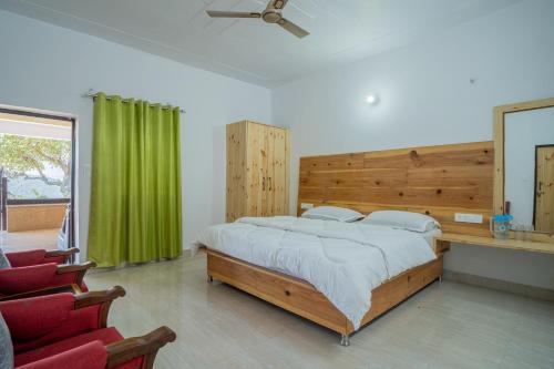 a bedroom with a large bed and a green curtain at Jaavi Homestay Nainital in Nainital