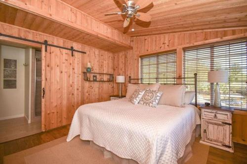 a bedroom with a bed and a ceiling fan at LaLa Land in Dadeville