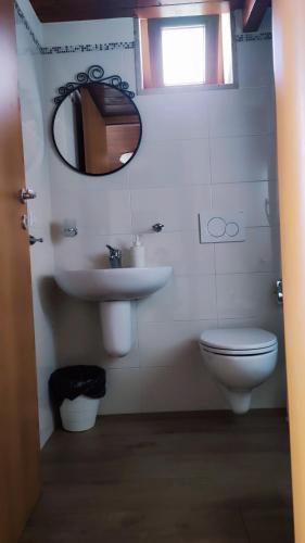 a bathroom with a sink and a toilet and a mirror at Panorama Lucano in Altamura