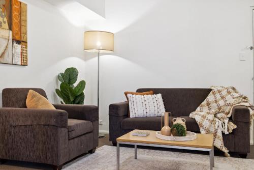 a living room with two couches and a coffee table at Prized Perth Retreat 1BDR in Perth