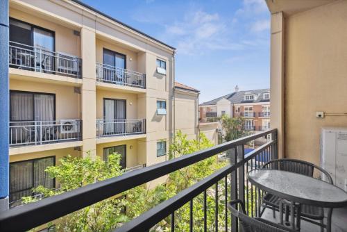 a balcony with a table and a building at Prized Perth Retreat 1BDR in Perth