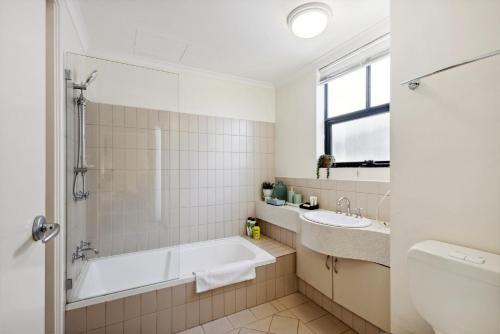 a bathroom with a tub and a sink at Prized Perth Retreat 1BDR in Perth