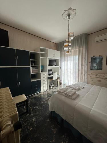 a bedroom with a large bed and a desk at Affittacamere da Elio e Renata in Calvi dellʼ Umbria